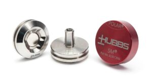 Two round metal parts that make up a SMR mount, along with a red cap with white lettering, on a white background.