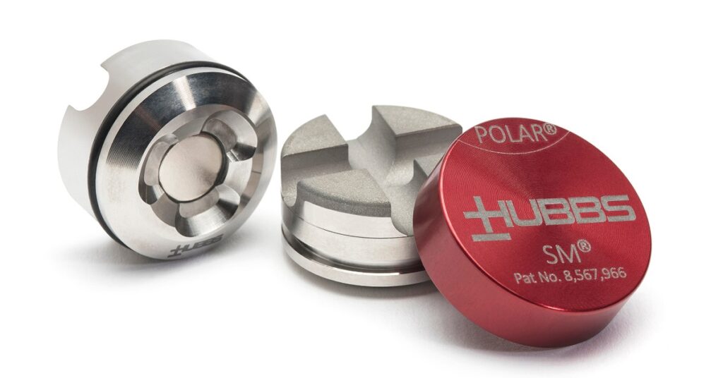 Three machined SMR mounting parts, including two silver pieces and a red cap that says HUBBS on it in white lettering.